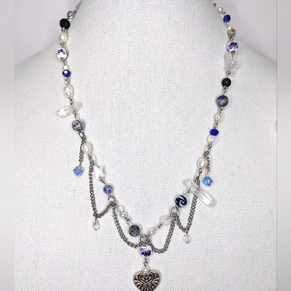 Necklace with pearls chain and a heart pendant and is blue. Handmade by me.